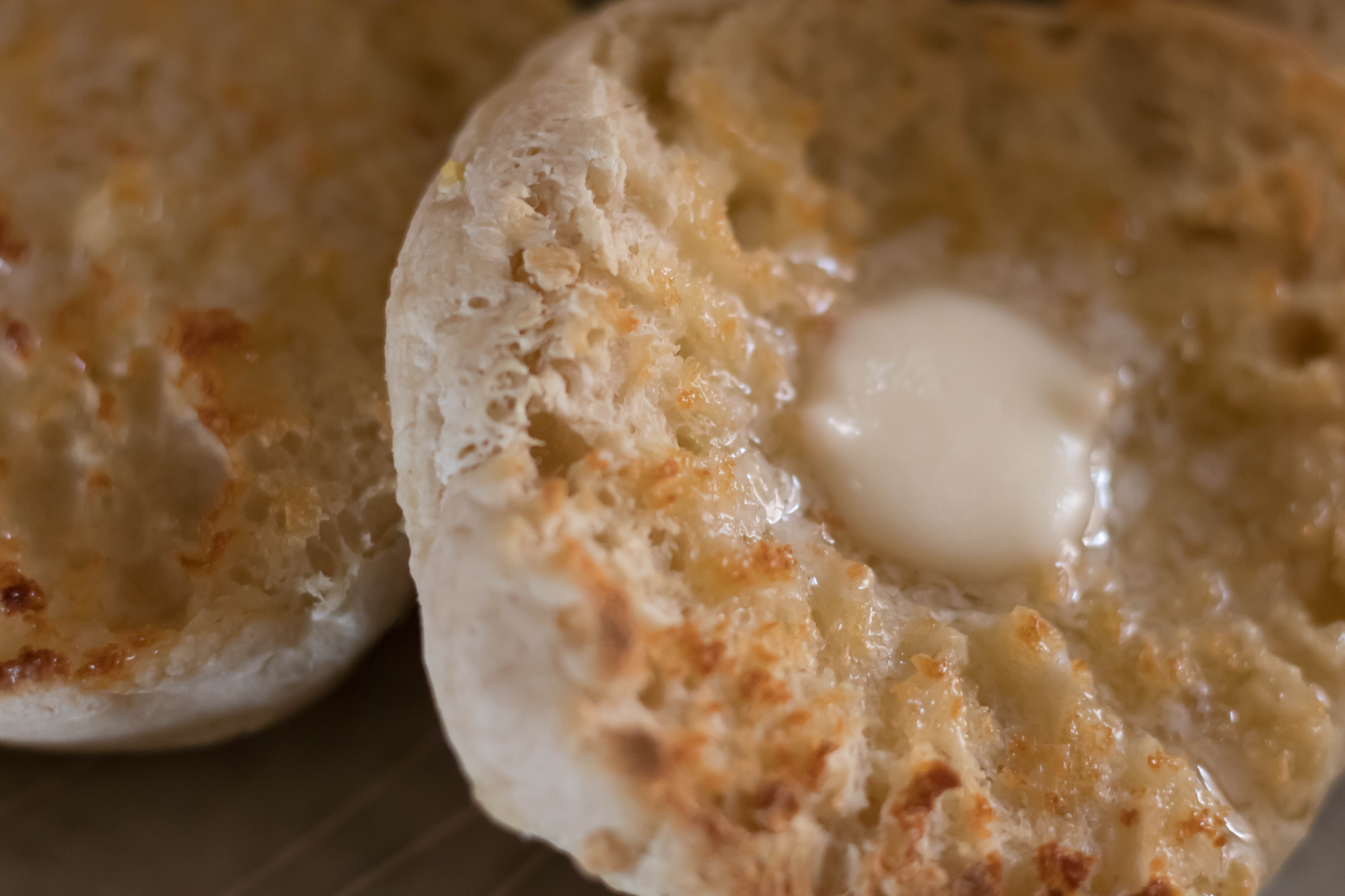 close up of butter on a sourdough english muffin